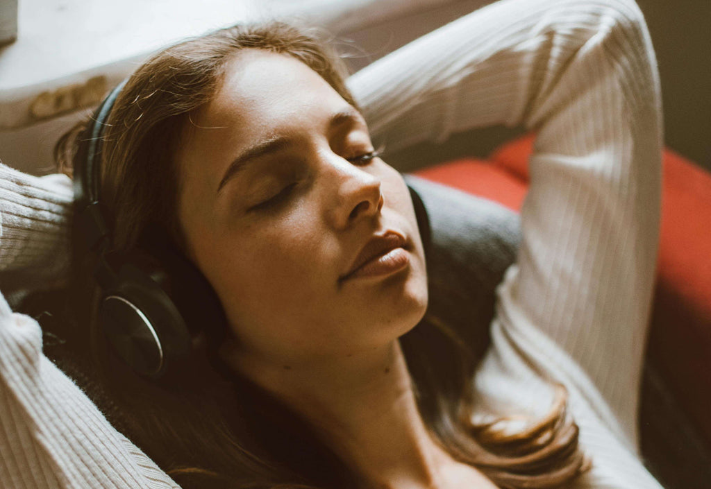 woman with eyes closed earphones on