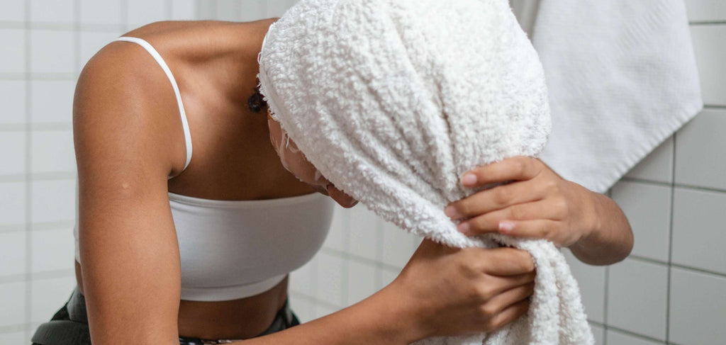 woman drying hair in towel