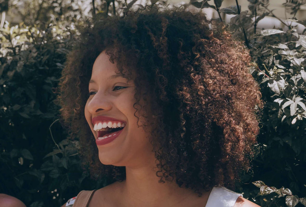 woman laughing coily kinky hair