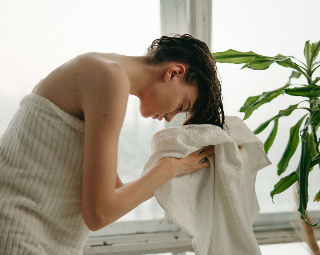woman washing her hair drying towel 
